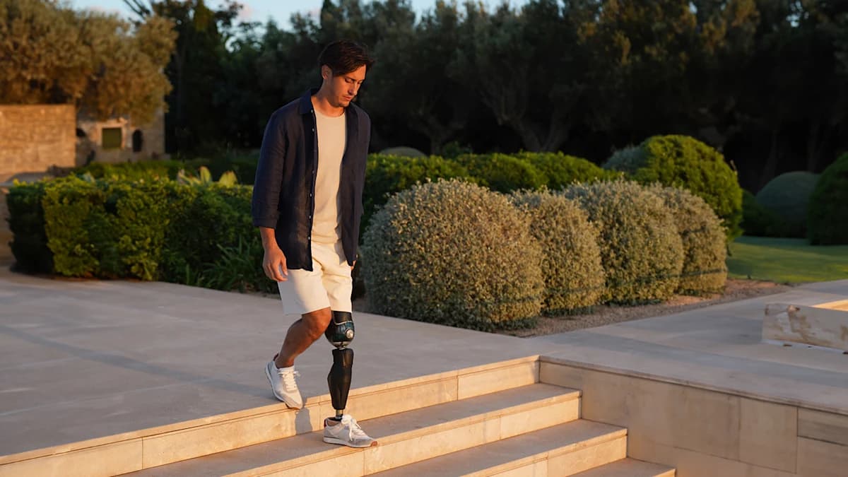 Alessandro Ossola walking down stone steps with his Evanto prosthetic foot.