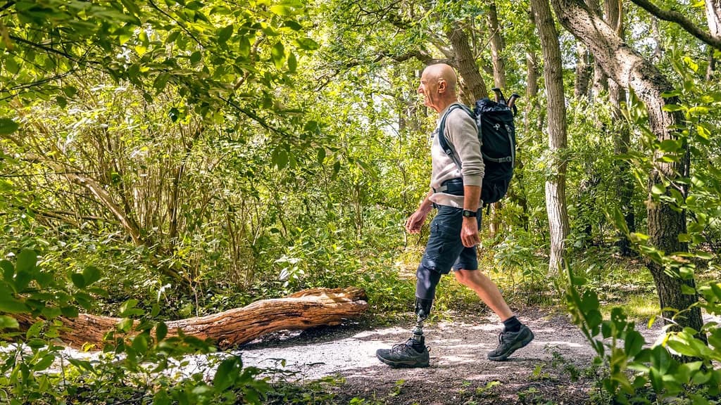 User walking in the forest with the Taleo Harmony prosthetic foot