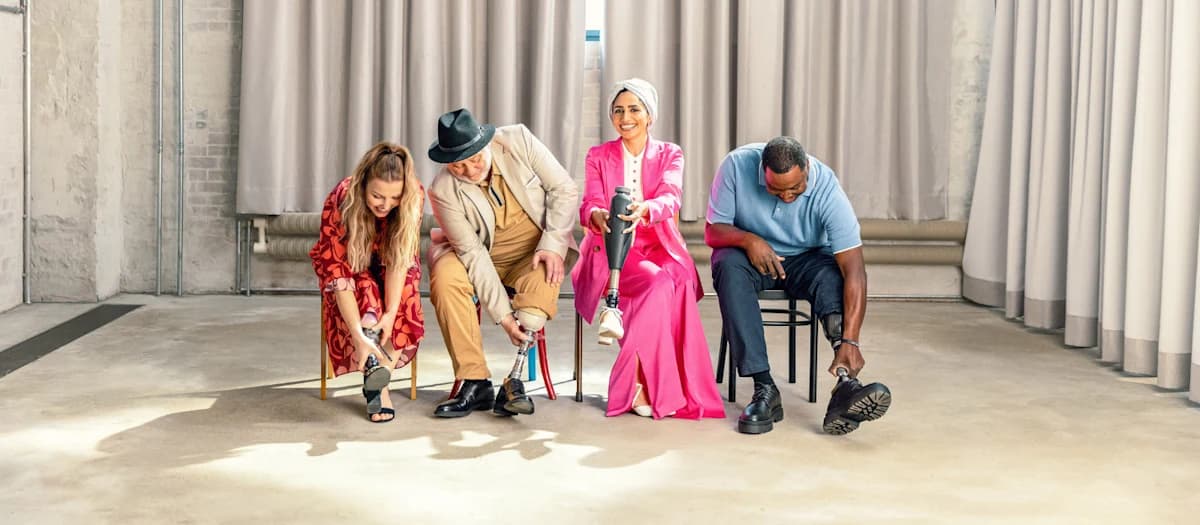 A diverse group of Taleo prosthetic foot users putting on their shoes