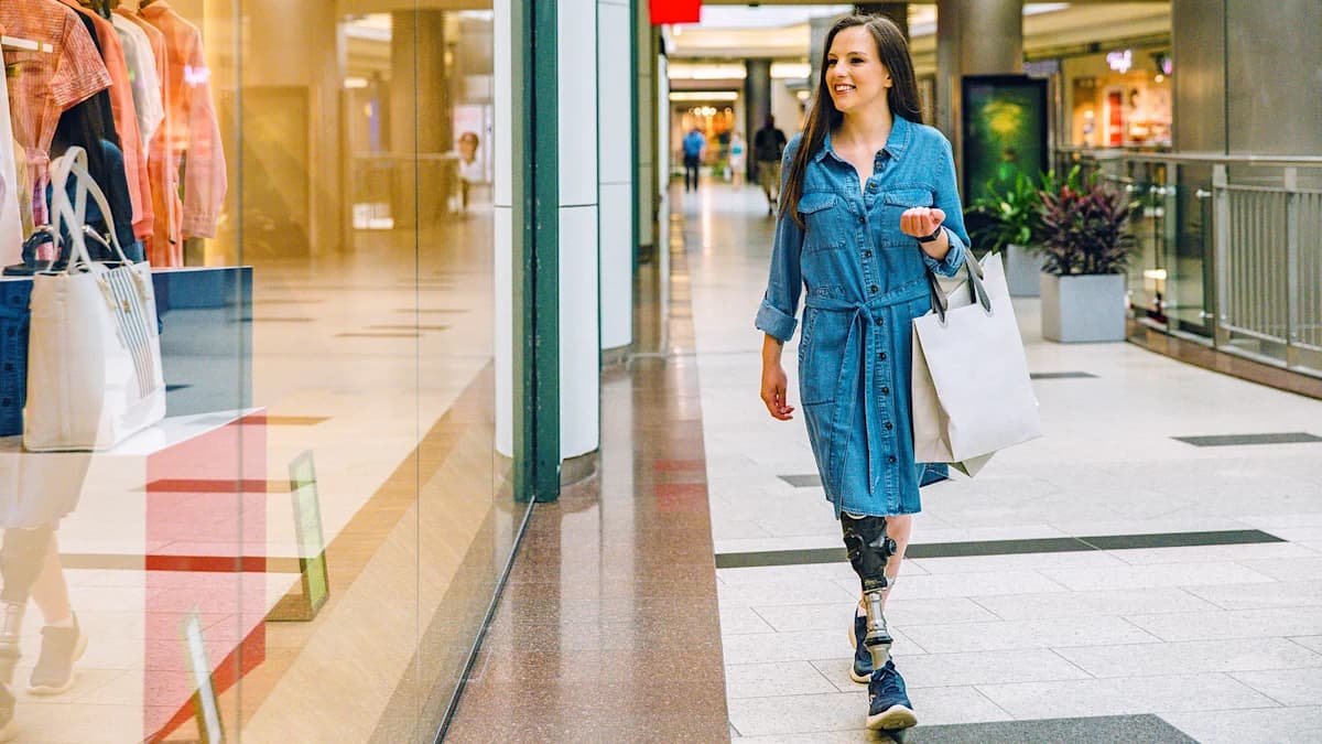 A female user wearing shopping bags while walking with her Taleo Vertical Shock foot.