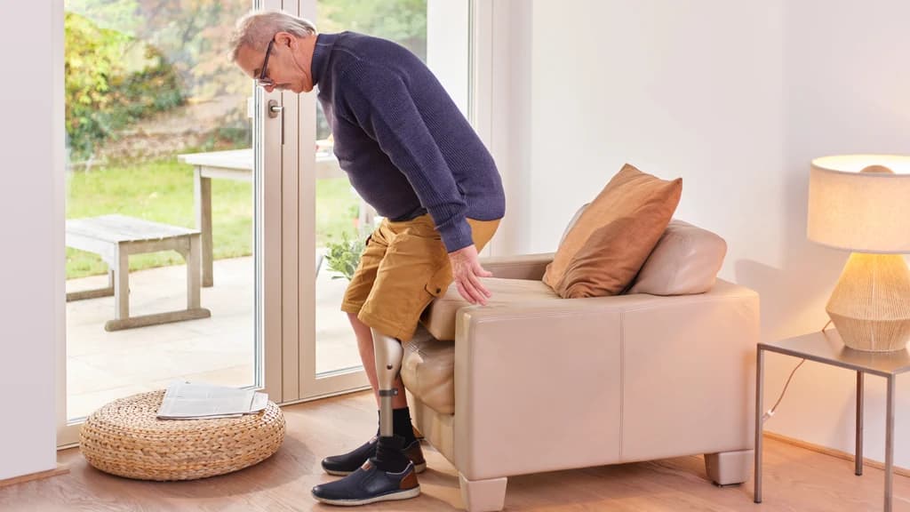 User sitting down using a microprocessor knee