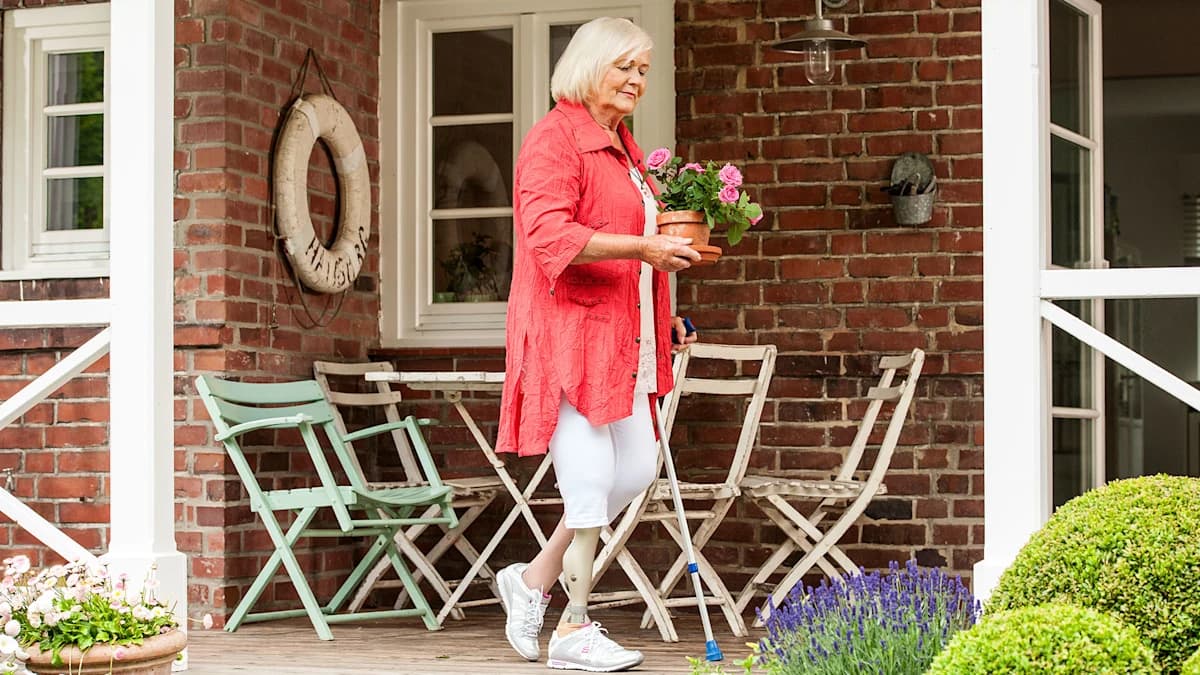 Person walking confidently outdoors with an Ottobock microprocessor knee.