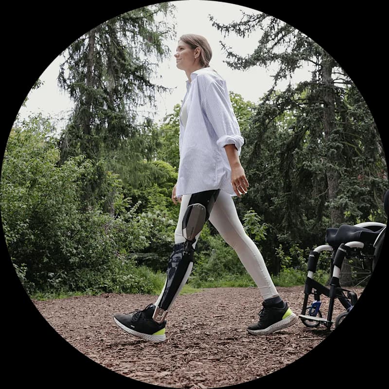 C-Brace user walking away from her manual wheelchair.