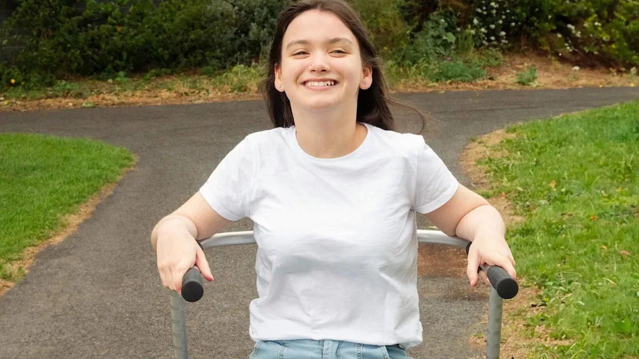 Cerebral Palsy patient walks with her walker.
