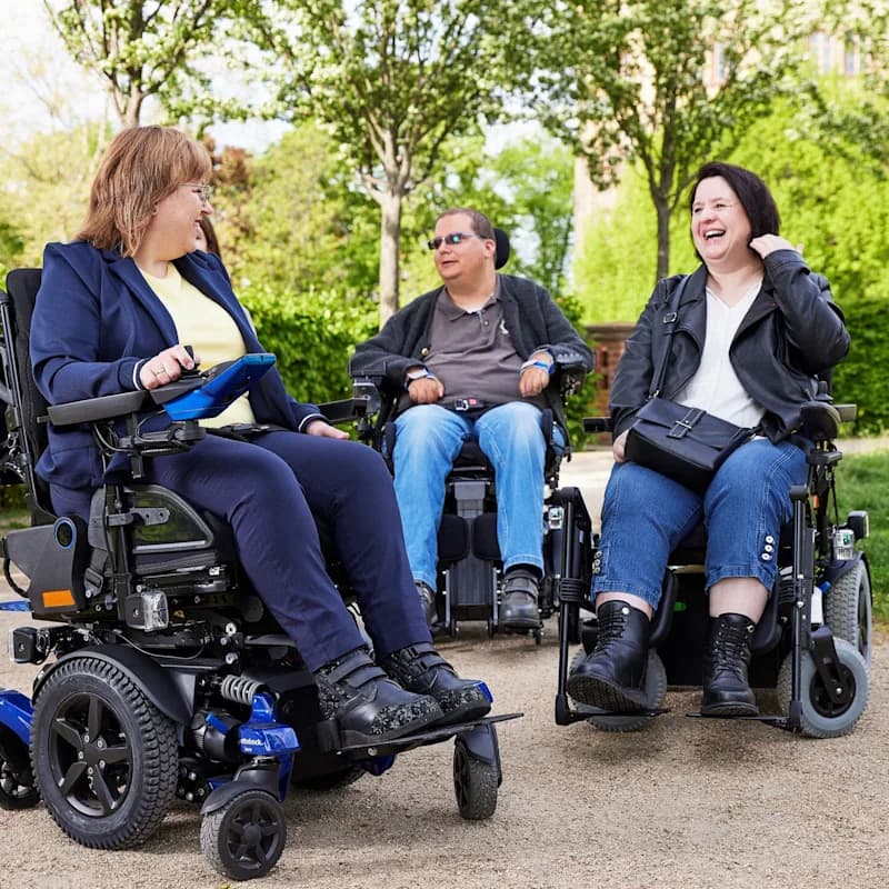 Two women and a man in their Juvo wheelchairs enjoying time together in Berlin.